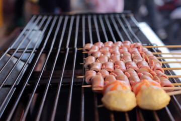Thai-Asian style barbecue meatballs called 'Mala' served with a rich chili sauce, sold as street food.