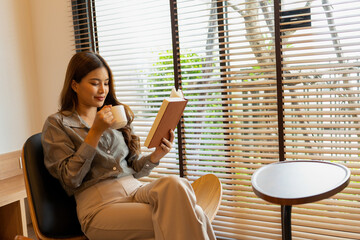 Woman enjoys book and music in modern abode.