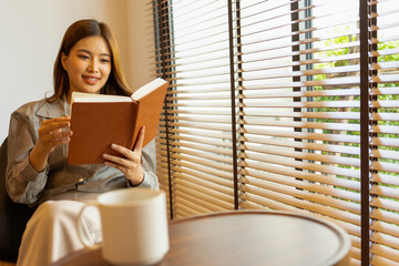 Woman enjoys book and music in modern abode.