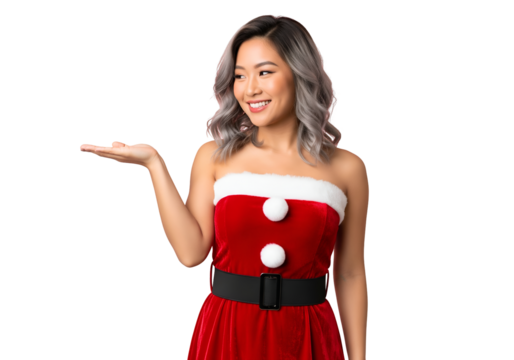 Smiling young asian woman wearing a strapless red and white santa claus costume holding out her hand to present something, isolated on transparent background