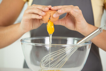 a young woman cooking in kitchen