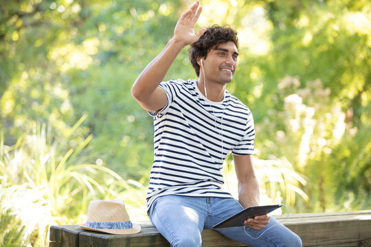 closeup portrait happy smiling regular young man relaxed in park