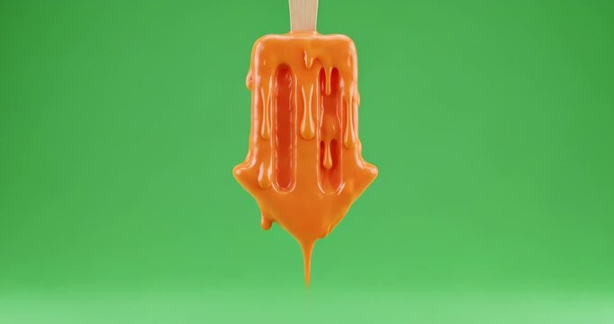 Melting orange popsicle dripping against a vibrant green screen background in a studio setting