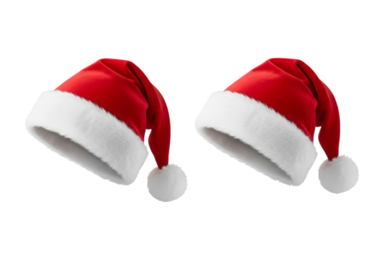 Two santa hats with white trim and pom poms on a black background for christmas holiday season