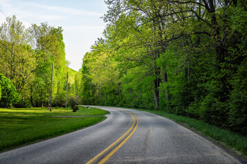 Lyndhurst, Virginia rural street winding Love road through mountains with well and car in appalachia spring summer