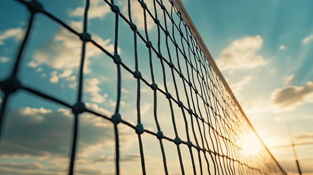 Sunset View of a Volleyball Net with Soft Clouds and Bright Sunlight in the Background at a Beach Setting