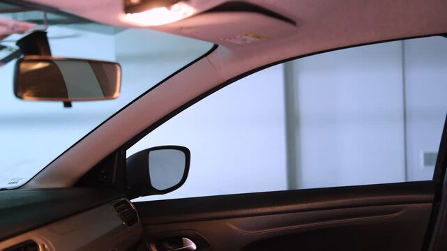 Interior view of a vehicle's electric window automatically closing in a modern automobile