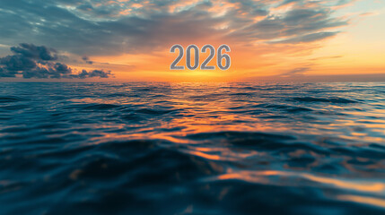 Bold glowing "2026" digits floating above the sea surface at sunset.