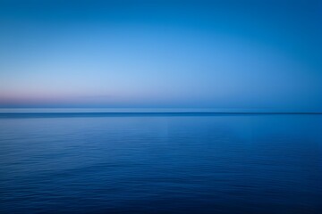 Obraz premium Tranquil Blue Seascape at Dawn with Soft Horizon and Calm Waters