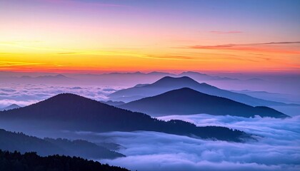 A beautiful landscape photograph of mountains silhouetted against a colorful sunset, with clouds filling the valleys below.