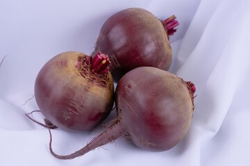 Three fresh beetroot vegetables isolated on white background