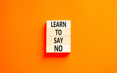 Learn to say no symbol. Concept words phrase Learn to say no on beautiful wooden blocks. Beautiful orange paper background. Business psychological Learn to say no concept. Copy space.