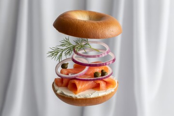 Smoked salmon bagel with cream cheese and red onion isolated on white background