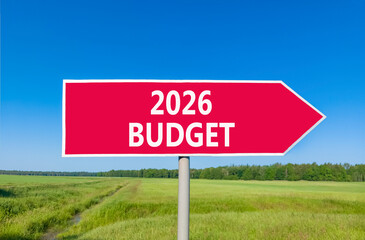 2026 Budget symbol. Concept words 2026 Budget on beautiful red road sign. Beautiful green grass field forest and blue sky background. Business and 2026 budget concept. Copy space.