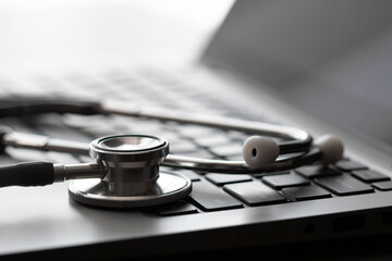 Medical Stethoscope on laptop or computer keyboard. Digital Health and Technology Concept