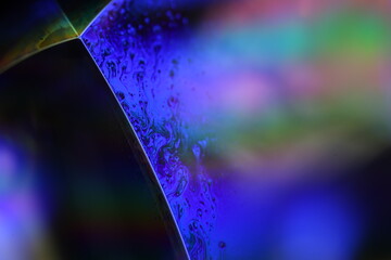 Purple liquid surface, phenomenal structure, green oils on a dark background, colourful abstract, surrealistic art, iridescent effect