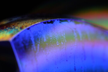 Purple liquid surface, phenomenal structure, green oils on a dark background, colourful abstract, surrealistic art, iridescent effect