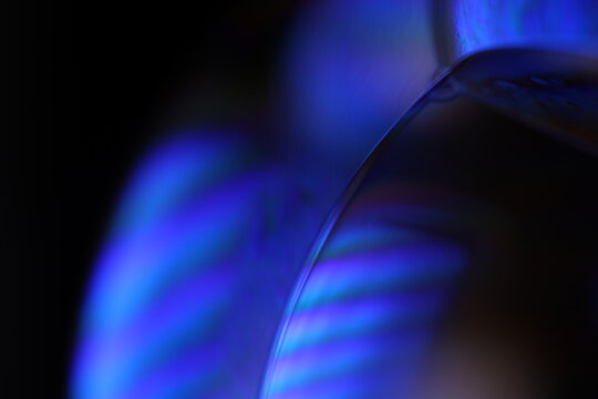 Purple liquid glowing flat film, colourful macro abstraction, interference pattern, glowing elements