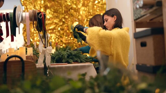 boutique maker preparing seasonal decorations at counter