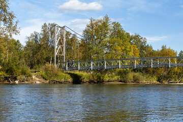 Suspension bridge hiking backpacking trail Swedish autumn river landscape
