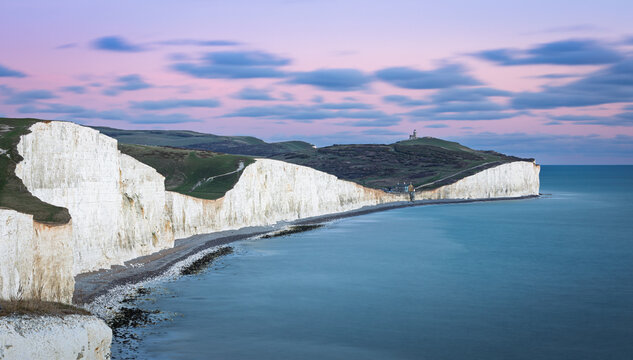 Blue hour evening view of Belle Tout lighthouse and Birling Gap from the cliff tops of the seven sisters on the east Sussex coast south east England UK - Powered by Adobe