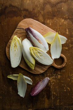 Group of fresh green Belgian endive or chicory and red Radicchio vegetables, also known as witlof salade