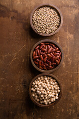 Assorted bowls with lentils, red beans and chickpeas — top view
