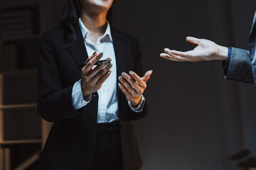 Business executive holding a pen and gesturing, having a serious discussion or negotiation with a colleague in an office setting