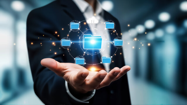 Businessman hand holding glowing digital data network interface with folder icon symbolizing cloud storage, data management, and secure information sharing in a modern office environment