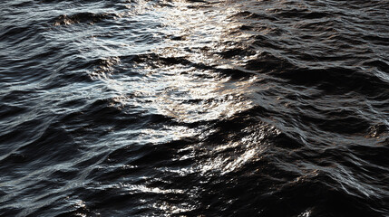 A mesmerizing view of the ocean with the sun's reflection on the water. The image features a close-up of the ocean's surface with sunlight glimmering upon it, creating a tranquil and reflective scene.