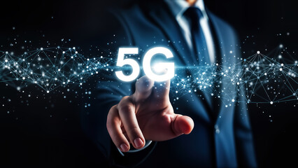 Businessman in suit touching glowing 5g text symbol surrounded by digital network connection particles on dark background representing future telecommunication technology