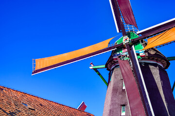 Vibrant abstract view of a historic windmill mechanism and colorful wings at Zaanse Schans.