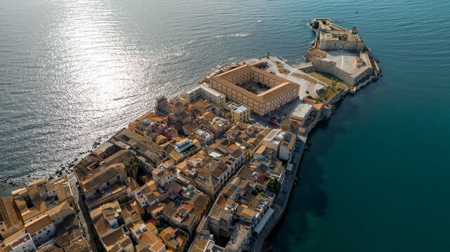 Aerial view of Castello Maniace situated at the far point of the Ortygia island promontory. It is an ancient citadel and castle in Syracuse, Sicily, southern Italy. It overlooks Mediterranean sea.