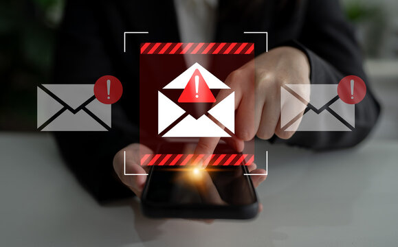 A smartphone displays email alert notifications with warning icons, highlighting user interaction in a sleek modern office environment. Emphasizes urgency and technology. Gantry