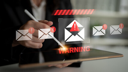 A digital device displays a warning alert for potential email threats, emphasizing the need for cybersecurity awareness and effective communication strategies. Gantry