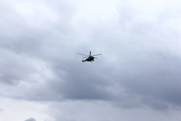 helicopter silhouette in the blue sky
