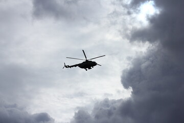 helicopter silhouette in the blue sky