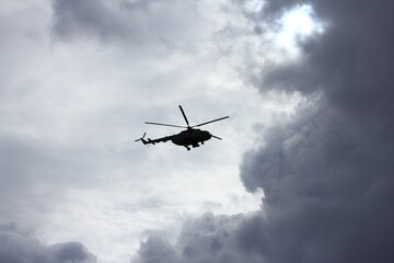 helicopter silhouette in the blue sky