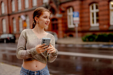 Young Woman Looking For Car On A Rainy City Sidewalk