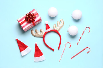 Christmas Blue Flat Lay with Reindeer Headband Gift Box and Santa Hats