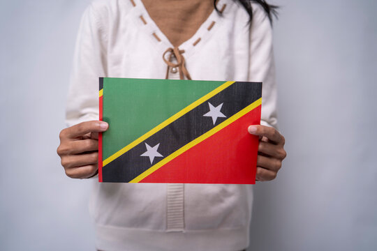 Person Holding the Saint Kitts and Nevis Flag