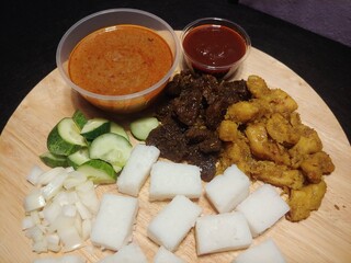 Close-Up shot of Grilled Stickless Beef and Chicken Satay served with Rice Cakes, Sambal and Peanut Sauce