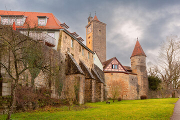 Historic city wall and medieval tower in Rothenburg ob der Tauber Germany with cloudy sky