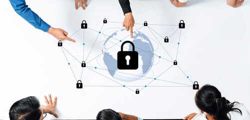 A diverse team collaborates on cybersecurity solutions, pointing at a digital illustration of a globe with locks, representing global network security and protection. Gantry