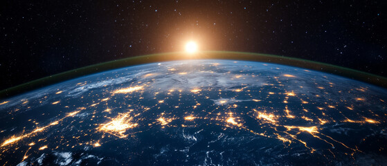 The Earth, illuminated by the night lights of cities and the sunrise from space, illustrates the scale of human activity, making it suitable as a scientific backdrop for educational materials.