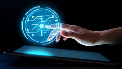 Close up of a human hand interacting with a glowing futuristic digital interface displaying a circuit board pattern on a dark background