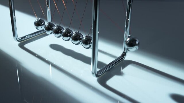 Newton's Cradle Pendulum Physics Demonstration with Chrome Steel Balls Showing Momentum Transfer and Energy Conservation
