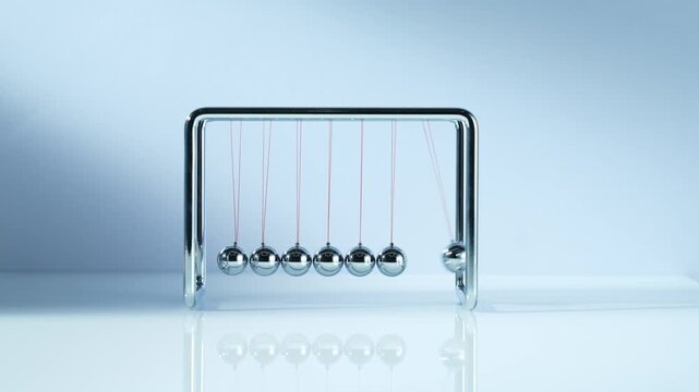 Newton's Cradle Pendulum Physics Demonstration Device with Chrome Steel Balls on Blue Background