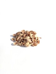 A pile of pistachio shells on a white background
