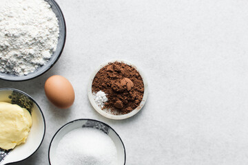 mise en place of ingredients for making chocolate cake, top view of chocolate cake ingredients